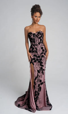 A woman poses against a light gray background wearing the Portia and Scarlett PS26074 long formal dress in black/nude, featuring a strapless sweetheart neckline, black floral patterns, and a thigh-high leg slit.