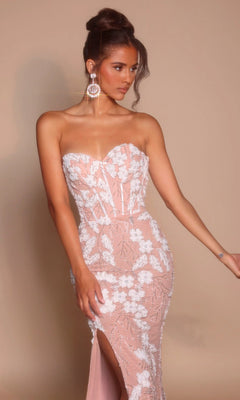 Model wearing the Portia and Scarlett PS26074 long formal dress, featuring a strapless sweetheart neckline, light pink floral embroidery, thigh-high slit, and statement earrings against a plain beige background.