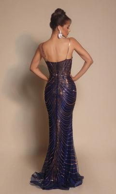 Woman wearing the Portia and Scarlett PS26095 long formal dress in dark blue with gold sequin lines, posing back to the camera with hands on hips and hair styled in an elegant updo.
