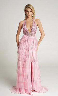 A woman stands against a plain light background wearing the Portia and Scarlett PS26117 long formal dress in pink, featuring a sleeveless deep V-neck, layered tulle skirt, and silver sequin embellishments.