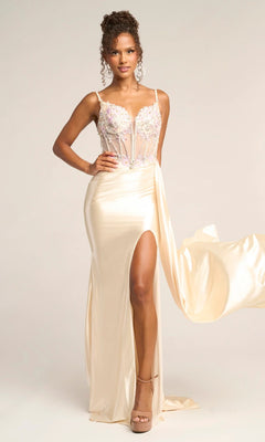 A woman models the Portia and Scarlett PS26270 long prom dress in cream, featuring a satin finish, sheer corset bodice with floral embroidery, spaghetti straps, and a high leg slit against a plain background.
