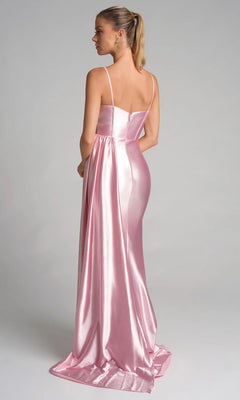 Woman wearing the Portia and Scarlett PS26270 long prom dress in shiny light pink satin with thin straps and a sheer corset bodice, standing with her back to the camera, hair in a ponytail, against a light gray background.