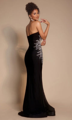 A woman poses against a plain beige background wearing the Portia and Scarlett PS26331E long formal dress, featuring a strapless sweetheart neckline and silver sequin detailing on the side.