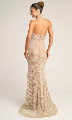 Woman in the Portia and Scarlett PS26425C, a strapless, floor-length gold sequin formal dress with a fitted silhouette, stands and looks over her shoulder against a plain background.