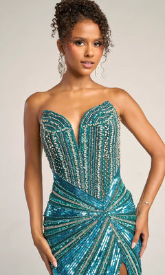 A woman poses against a plain background wearing the Portia and Scarlett PS26431C long formal dress, featuring a strapless design, teal sequins and beads, and a plunging v-neckline.