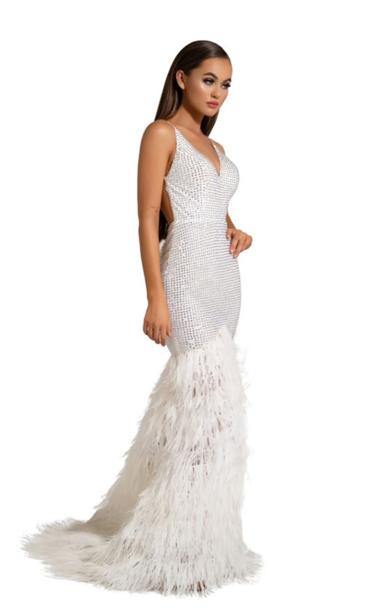 A woman wears the Long Formal Dress PS6826 by Portia and Scarlett—a white mermaid gown with a fitted, beaded bodice, feather-trimmed skirt, and chic V-neckline—posed against a plain white background.