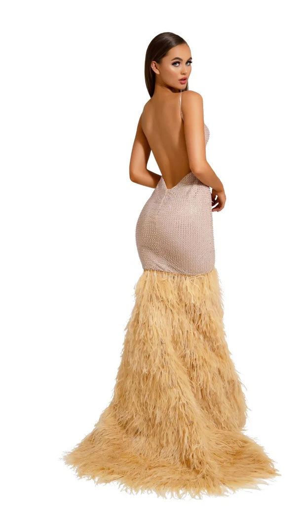 A woman poses in the Long Formal Dress PS6826 by Portia and Scarlett, featuring a backless, fitted light-tone mermaid silhouette with a feathered skirt that flares dramatically from the knees to the floor.