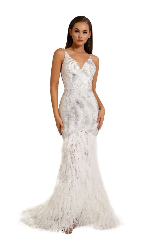 A woman stands against a plain white background wearing the Portia and Scarlett Long Formal Dress PS6826, featuring a white beaded bodice, v-neckline, and feathered mermaid-style skirt.