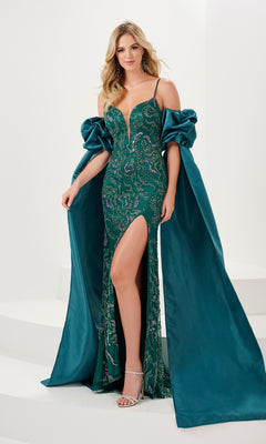 A woman in the Sequin-Print Draped-Sleeve Long Prom Dress 14155, featuring a green sequin print, thigh-high slit, and dramatic off-the-shoulder sleeves, stands on white steps.