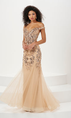 A woman stands on a white background wearing the Long Prom Dress 14185 by Panoply—an off-the-shoulder, floor-length mermaid dress with sequin embroidered floral embellishments.