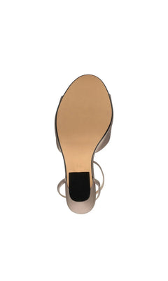 Quinn Champagne Prom Shoes: Touch Ups 4699 champagne-colored open-toe high-heeled sandal, shown from the underside to reveal the sculpted heel.