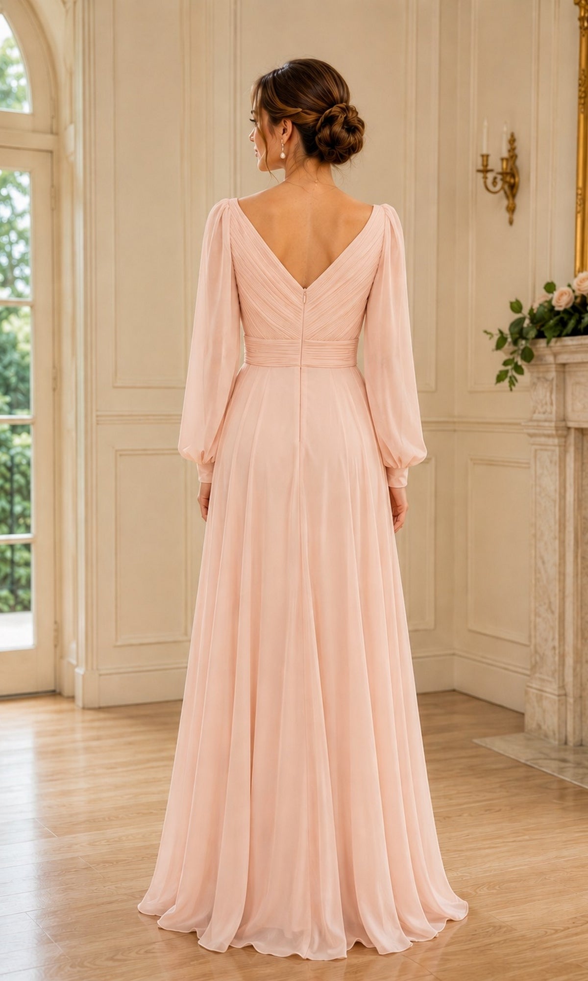 Back view of the Rina Di Montella R104 Long Sleeve A-Line Chiffon Formal Dress, a floor-length pale pink gown with a V-neck and long, sheer bishop sleeves.