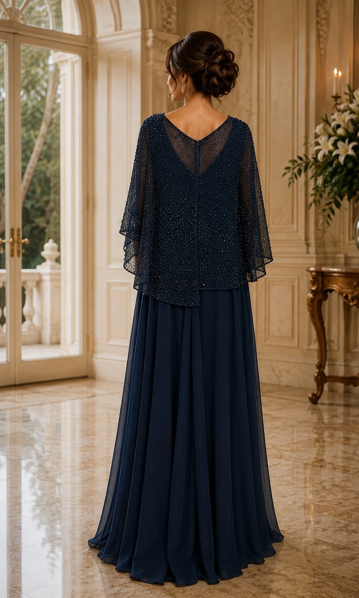 Back view of the Rina Di Montella R107 Beaded Cape Long Formal Dress, a floor-length navy blue gown with a sheer, beaded cape overlay perfect for a formal holiday event.