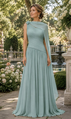A woman wears a sage green Rina Di Montella R110 one-shoulder cape long formal dress, a floor-length chiffon gown featuring a draped bodice and an attached cape overlay.