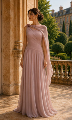 A woman wears a vintage rose One Shoulder Cape Long Formal Dress: Rina Di Montella R110, featuring a floor-length chiffon skirt, a pleated bodice, and a draped cape sleeve.