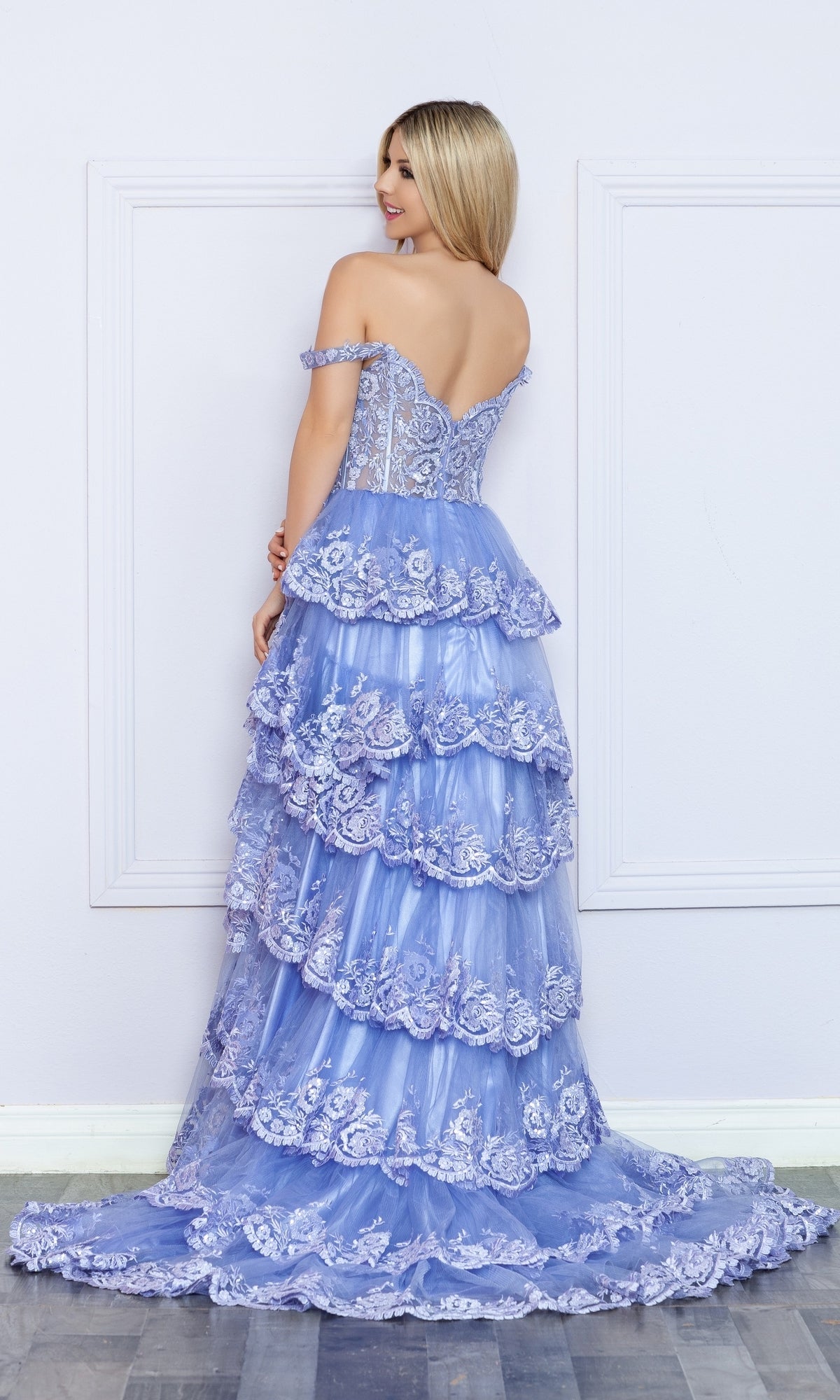 A woman in the Nox Anabel Off-the-Shoulder Lace Prom Dress R1299.