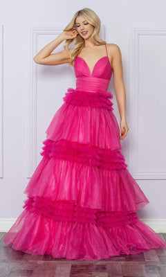 A woman stands indoors, smiling as she touches her hair, wearing the Nox Anabel Ruffled Glitter Prom Dress R1316—a bright pink gown with a tiered tulle skirt, deep V-neckline, and spaghetti straps.