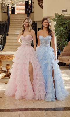 Two women stand indoors side by side in strapless, high-slit Nox Anabel R1688 prom ball gowns—one in pink, the other in blue.