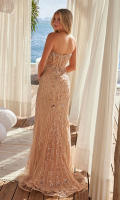 A woman wears the Nox Anabel R1695, a strapless long beaded prom dress with a sparkling sheer overlay, standing on a wooden deck near white curtains and waterfront scenery, looking over her shoulder.