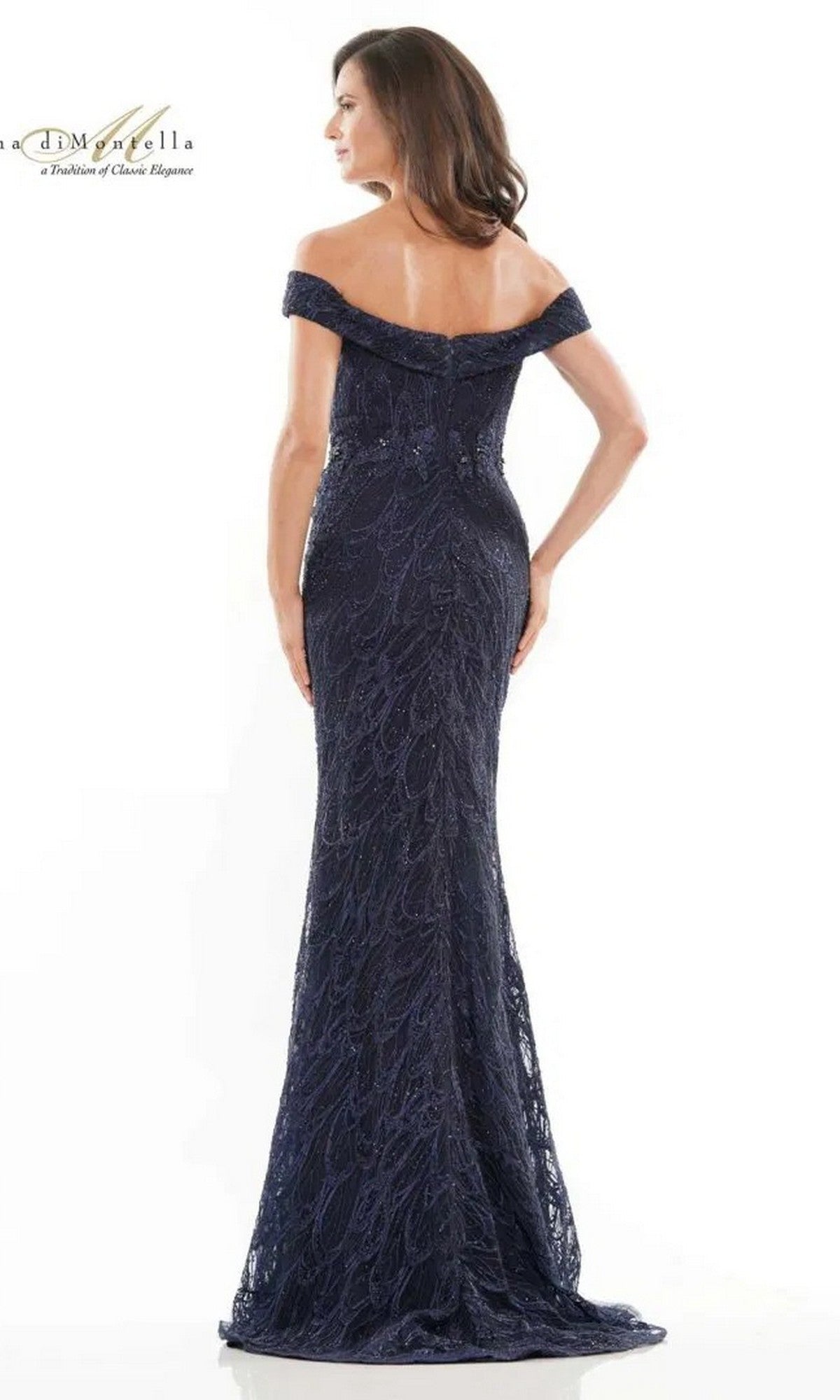 A woman is shown from the back in a Rina Di Montella RD2739 Long Formal Dress—an off-the-shoulder, floor-length dark blue gown with intricate lace—posed against a white background.