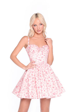 A woman poses in the Blush Rose Print Floral Casual Mini Dress: Rosalind, featuring a fitted bodice and an a-line skirt with a floral print, against a white background.