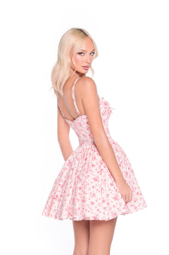 A woman models the Blush Rose Print Floral Casual Mini Dress: Rosalind, posing against a white background with her a-line skirt gently flowing as she looks over her shoulder.