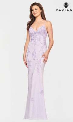 Woman wearing a fitted, light pink Faviana prom dress with floral embroidery, thin straps, strappy back, and slight flare at hem; Faviana logo in top right corner.