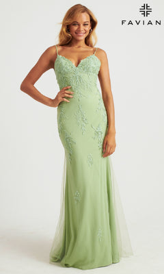 A woman wearing the Strappy-Back Long Light Pink Prom Dress by Faviana stands smiling against a plain white background. The gown features spaghetti straps, a fitted bodice, and displays the "FAVIAN" logo.