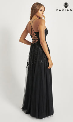A woman models the Faviana Embroidered A-Line Long Prom Dress, a black lace gown with a lace-up back and 3D floral embroidery, as she poses looking over her shoulder against a plain white background.