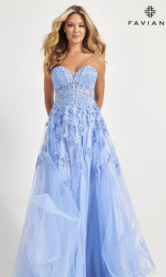 A woman models the Faviana Strapless Sweetheart Long Lace Prom Dress, featuring a light blue floral lace bodice and tulle skirt, standing against a white background with the Faviana logo in the top right corner.