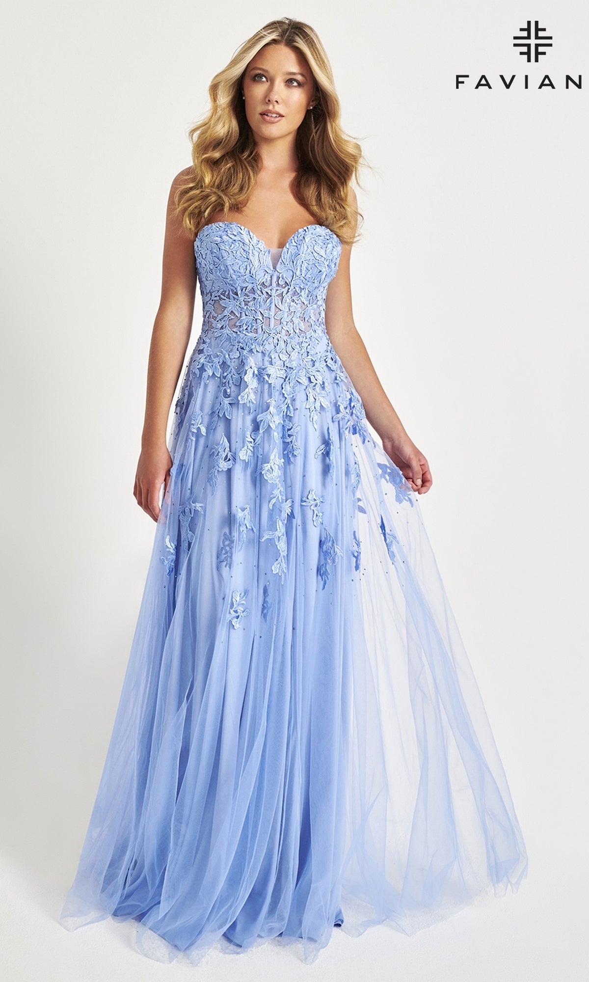 A woman models the Faviana Strapless Sweetheart Long Lace Prom Dress in light blue. This floor-length gown features floral appliqué details and a lace design, with the brand name 