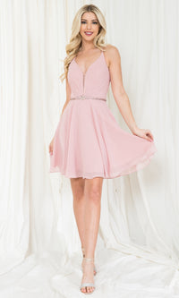 Woman wearing a short light pink dress against a white background