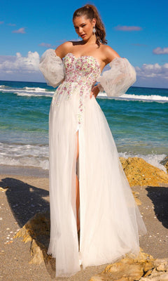 A woman stands on the beach wearing the Long Sleeve Strapless Long Prom Dress SU070, featuring embroidered flowers, sheer removable long sleeves, and a high slit skirt.