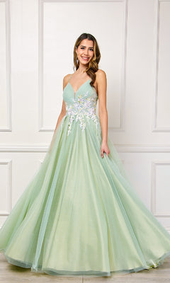 A woman in the Amelia Couture SU088 long pastel prom ball gown stands smiling before a white paneled wall.