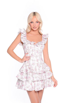 Model wears the Floral Print Ruffled Backless Sundress: Seraphine, featuring ruffled straps and a tiered skirt, against a plain white background.