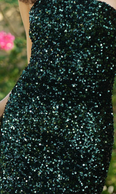 Close-up of a person wearing the Velvi One-Shoulder Long Sequin Prom Dress Stardust in dark green, with a blurred outdoor background.
