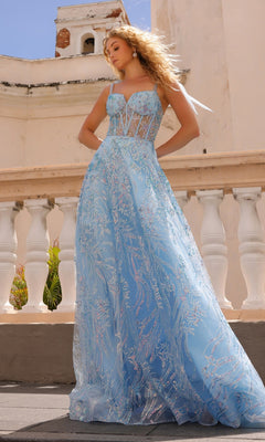 A woman stands outside a pale building in the Sequin Long Prom Ball Gown with Shoulder Bows T1336, a light blue, floor-length A-line dress featuring a corset-style bodice and silver embroidery.