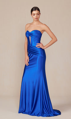 A woman wears the Nox Anabel T1500, a strapless royal blue satin prom dress with a corset bodice and slight train, standing against a plain beige background.