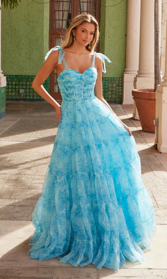 A woman stands in a sunlit courtyard wearing the Nox Anabel T1501 Tie-Dye Long Ruffle Prom Dress.