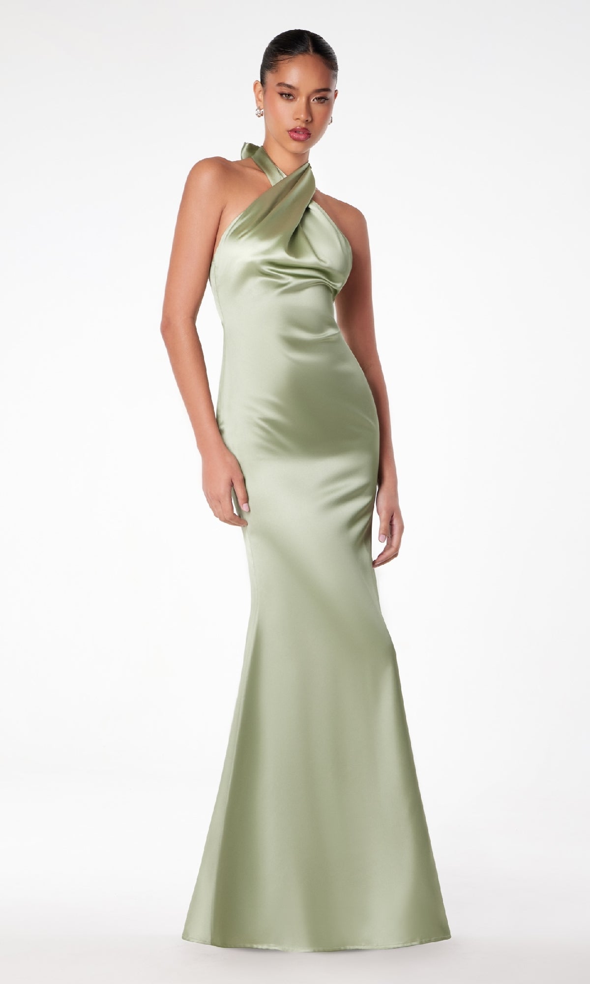 A woman wearing the Astee T2005 Criss-Cross Halter Long Prom Dress in light green stands against a plain white background.
