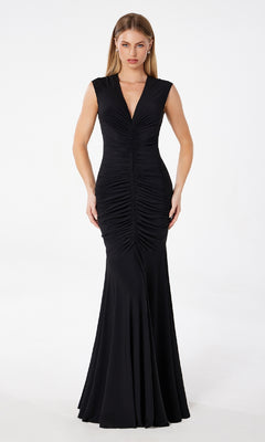 A woman stands against a white background wearing the Astee T2009 Cap-Sleeve Long Ruched Prom Dress, featuring a floor-length design and ruched detailing down the front.