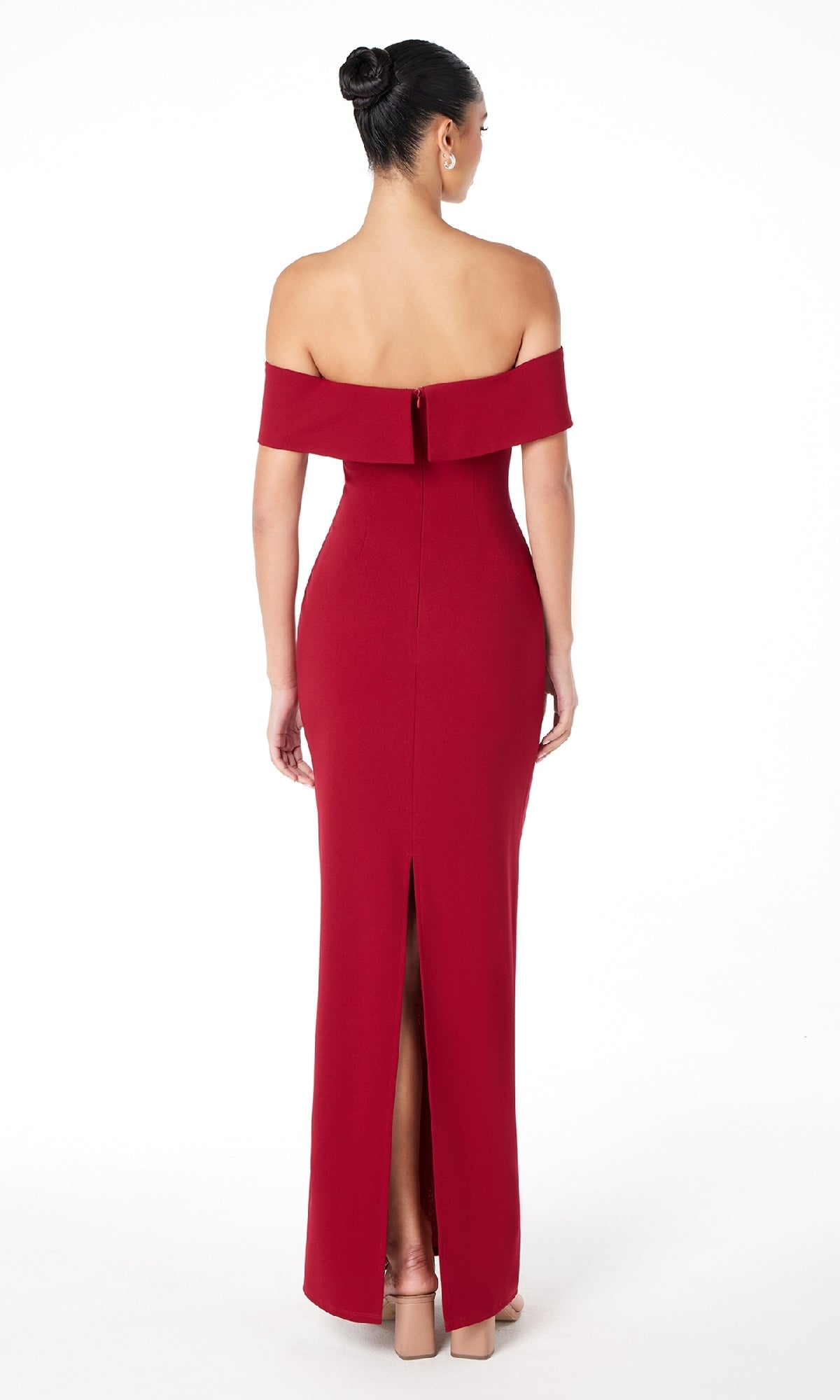 A woman with an elegant updo is pictured from behind, modeling the Astee T2011 Off-the-Shoulder Long Prom Dress—a fitted, floor-length gown with a back slit—against a white background.