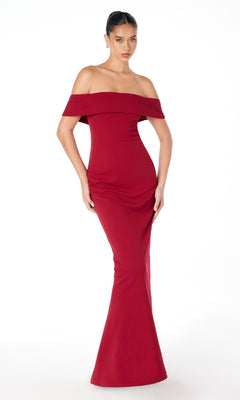 A woman models the Astee T2011 Off-the-Shoulder Long Prom Dress, a fitted, floor-length red evening gown, standing against a plain white background.