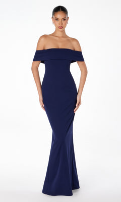 A woman models the Astee T2011 Off-the-Shoulder Long Prom Dress, a fitted, floor-length navy gown, standing against a plain white background.