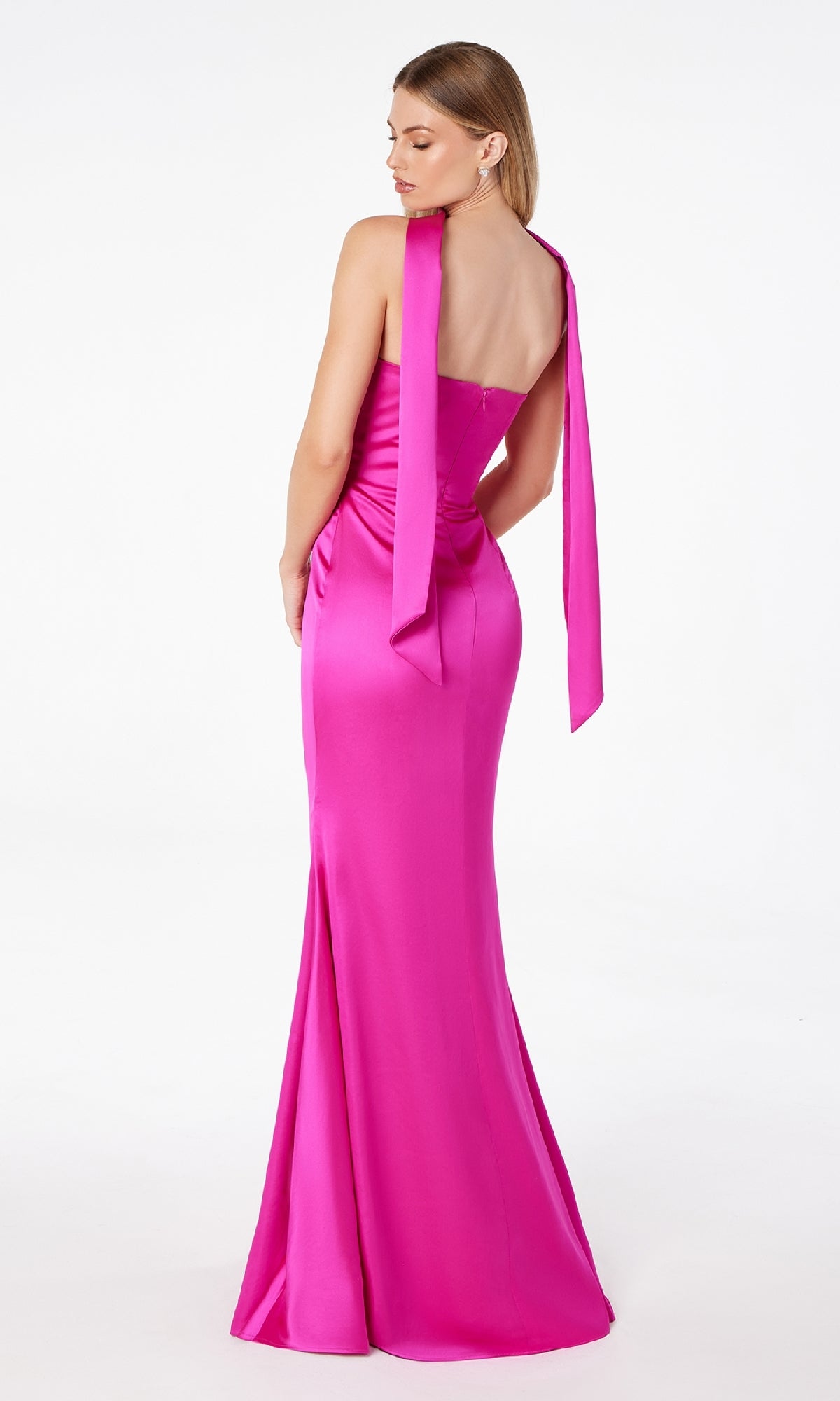 A woman stands facing away in the Astee T2012 Choker-Sash Strapless Long Prom Dress: a sleeveless, floor-length bright pink formal gown with a fitted bodice and long sash detail.