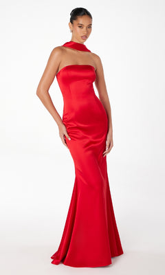 A woman in the Choker-Sash Strapless Long Prom Dress: Astee T2012, a fitted floor-length satin gown with a matching neck sash, stands against a plain white background.