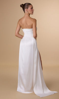 A woman with her hair in a bun faces away, modeling the Amoris T215W Strapless Long Satin Prom Dress with a high slit, set against a plain beige background—an elegant formal option under $150.