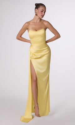 A woman wears the Strapless Long Satin Prom Dress CLT215 in light yellow, featuring a thigh-high slit, while standing against a plain white background.