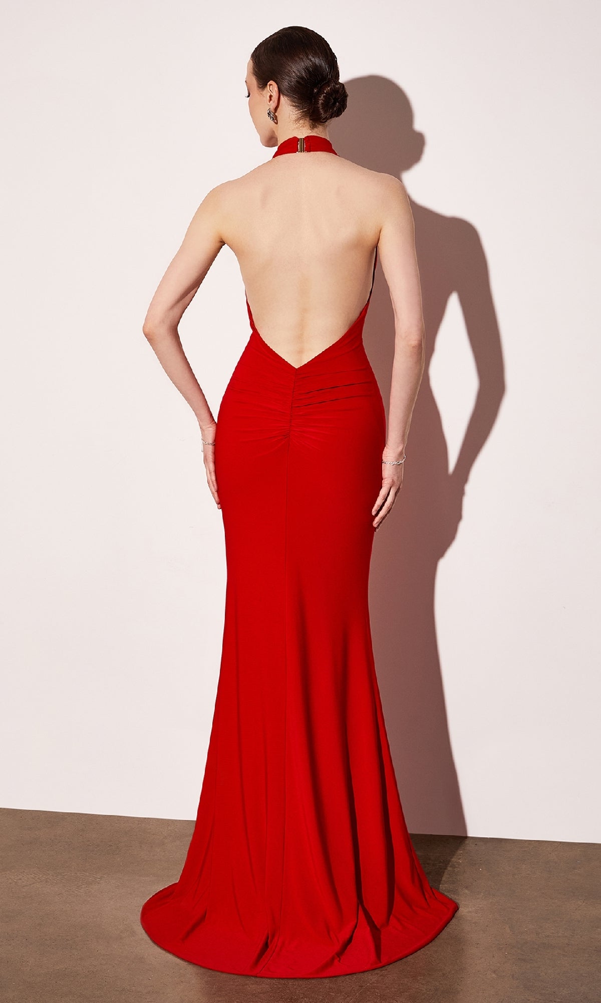 Red evening gown with open back on a white background