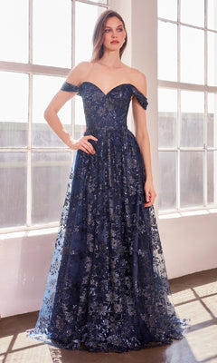 Wearing the Amoris T607, a long glitter-print prom dress, a woman stands by large sunlit windows.